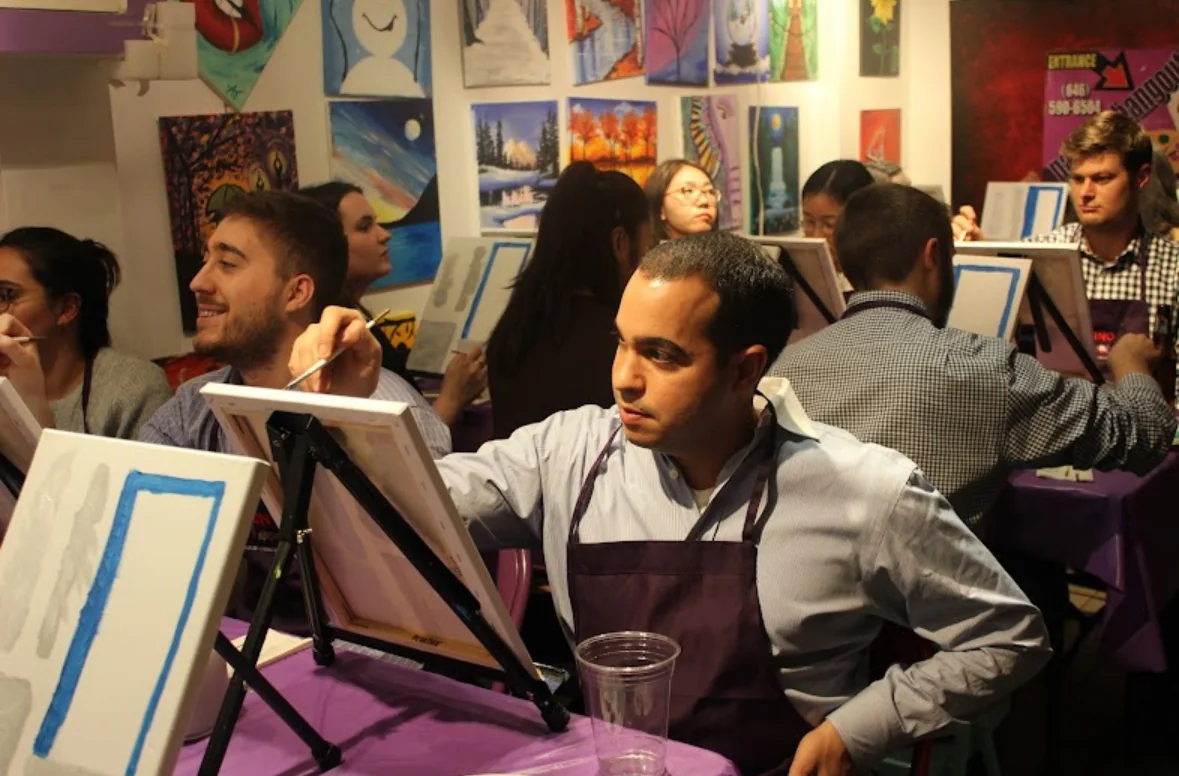 Guests painting together at their easels