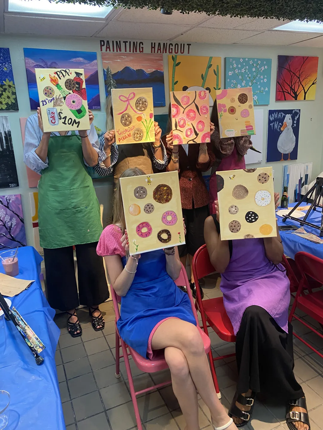 Guests displaying their personalized painting designs