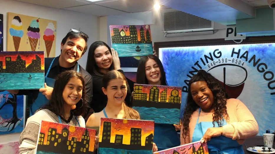 Friends showing their finished paintings