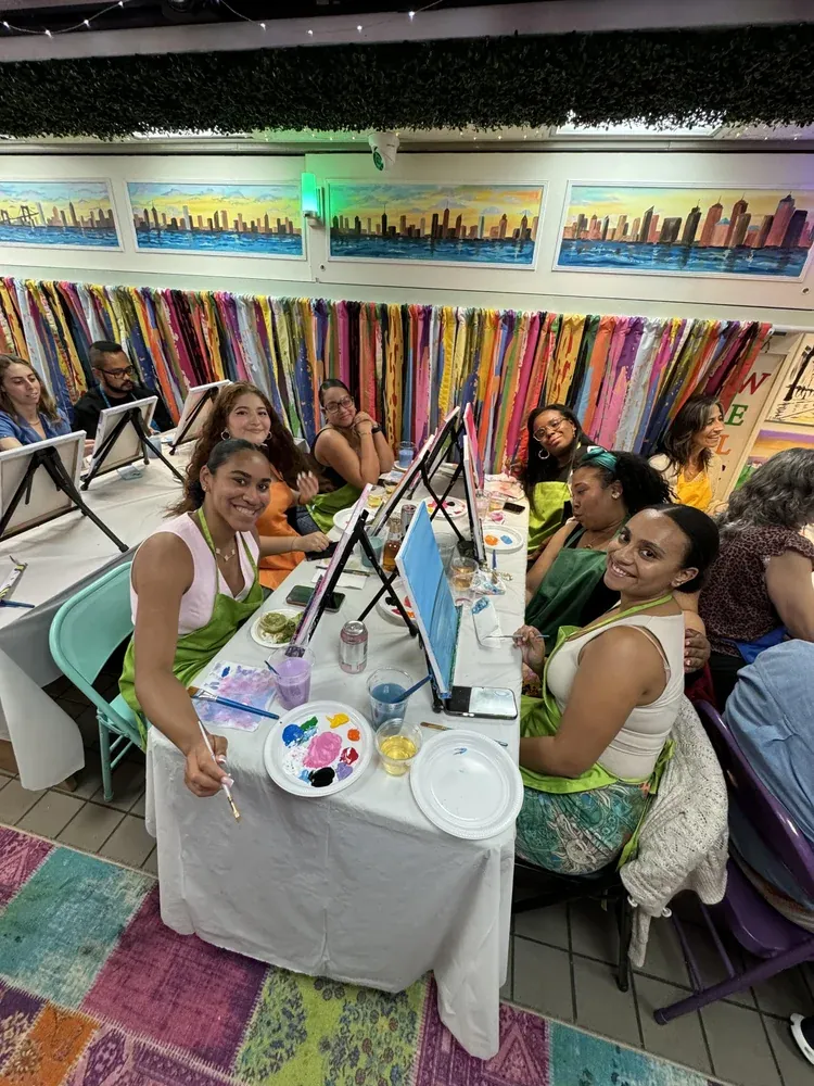 Guests painting together around a shared table