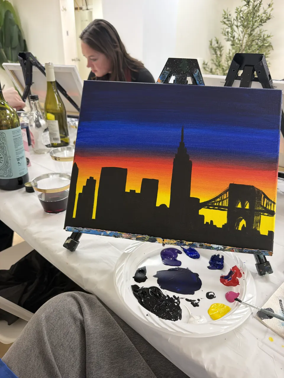 A colorful sunset cityscape painting and paint palette